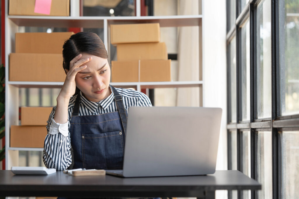 Local SEO Services 1 frustrated local business owner laptop box shelves